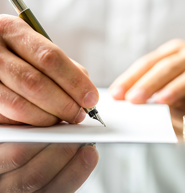 Closeup of a man signing  divorce papers.